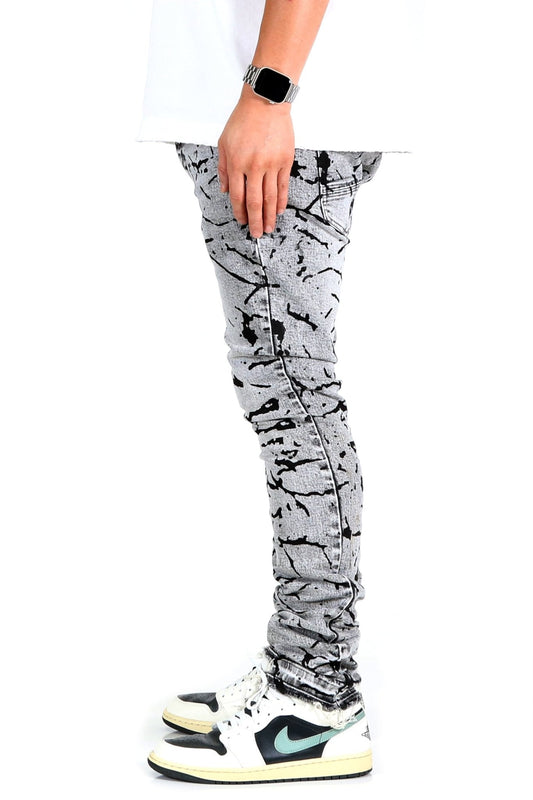 Side view of black and white graphic print skinny denim pants.