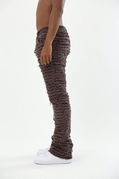 Side view of brown skinny jeans paired with white sneakers.