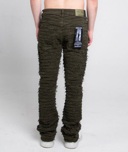 Back view of green fitted jeans with visible tag.