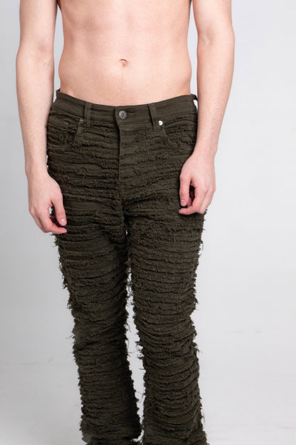 Front view of green fitted jeans with five pockets.