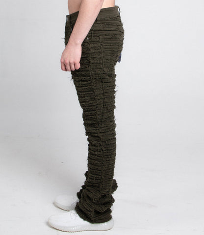 Side view of green fitted jeans with five pockets.