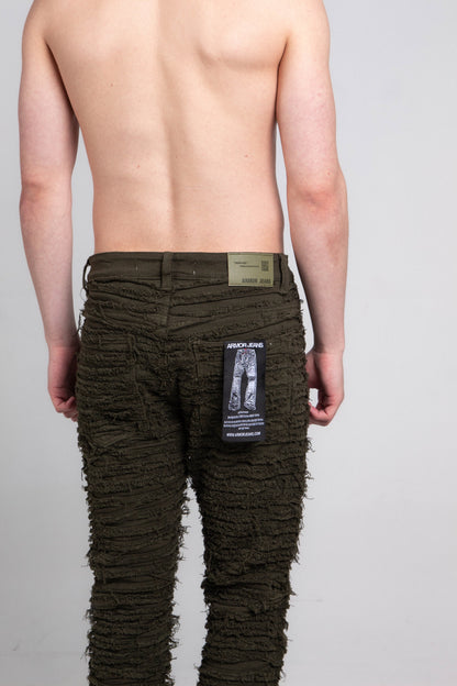 Back view of green slim fit jeans with tag attached.