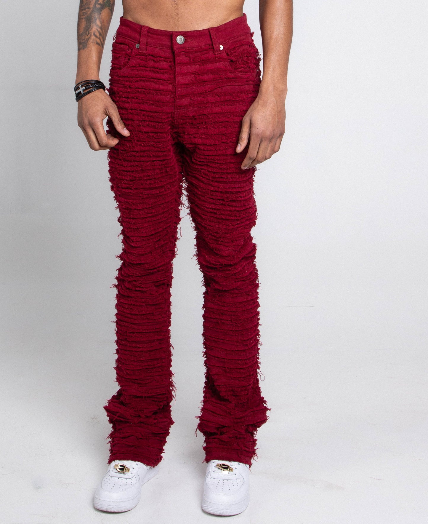 Front view of red fitted jeans featuring five pockets.