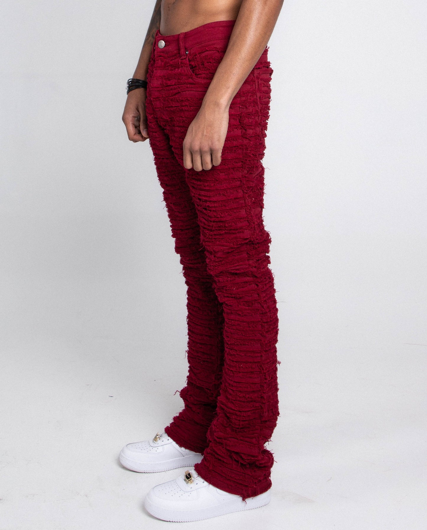 Front view of red skinny jeans styled with white sneakers.