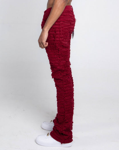 Side view of red skinny jeans featuring pockets.