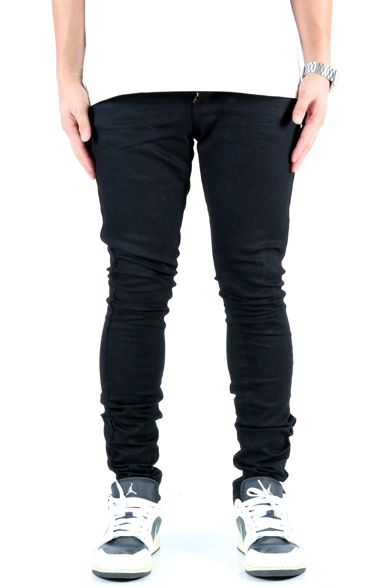 Front view of the black skinny jeans with pocket details