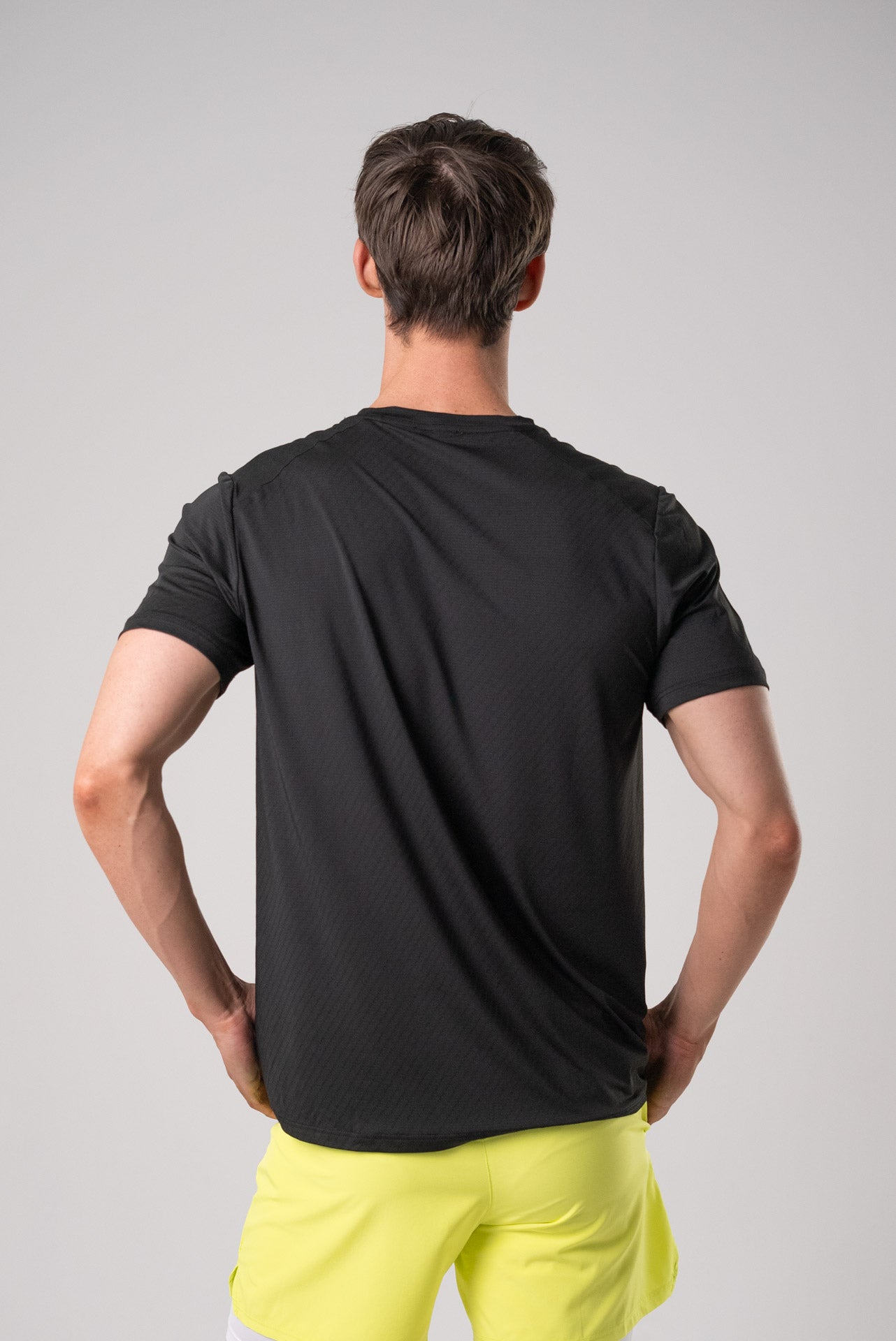 Back view of the black Alive Strong Tee with a casual fit.