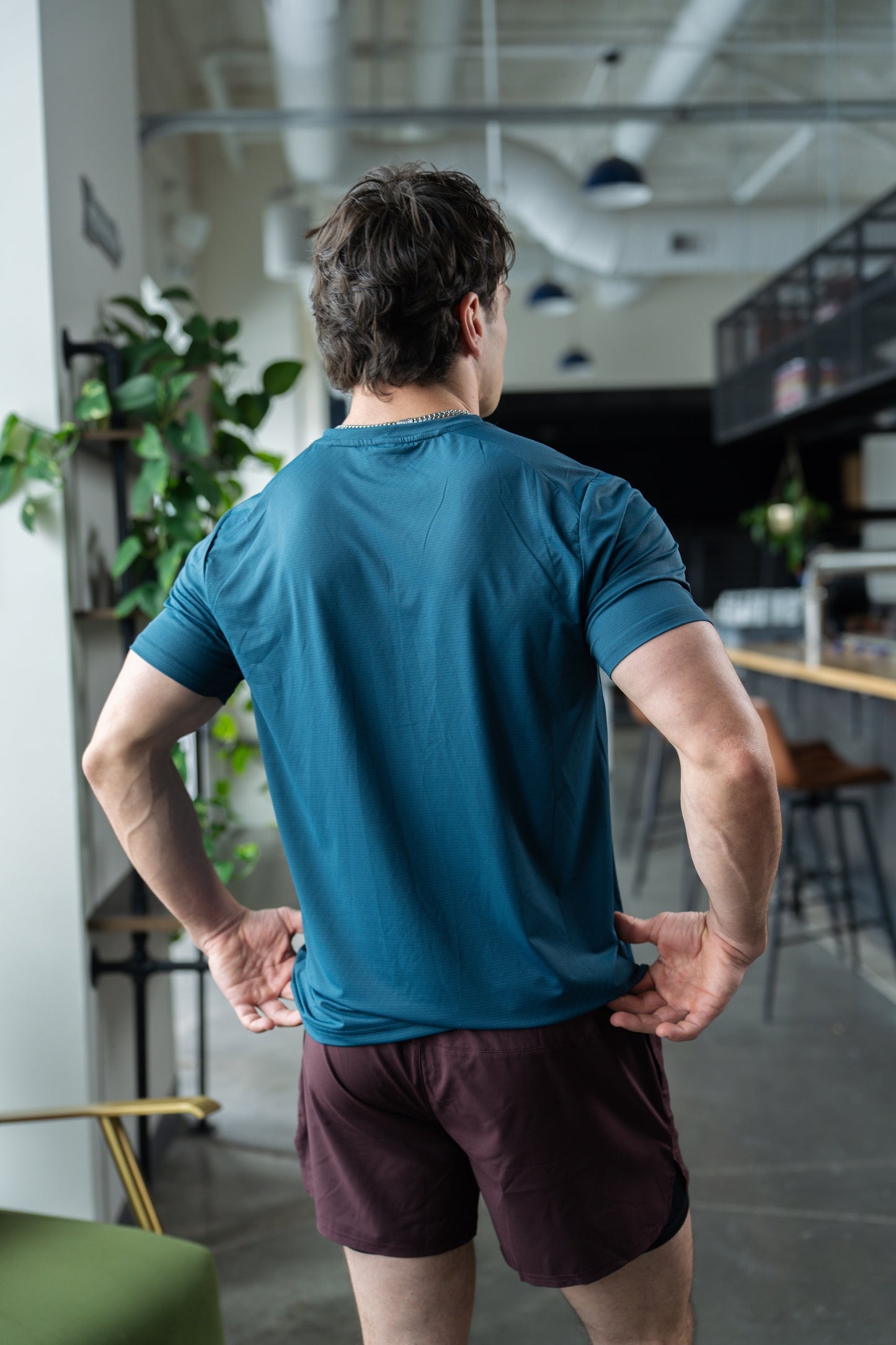 Back view of the blue active tee featuring short sleeves and round neckline.