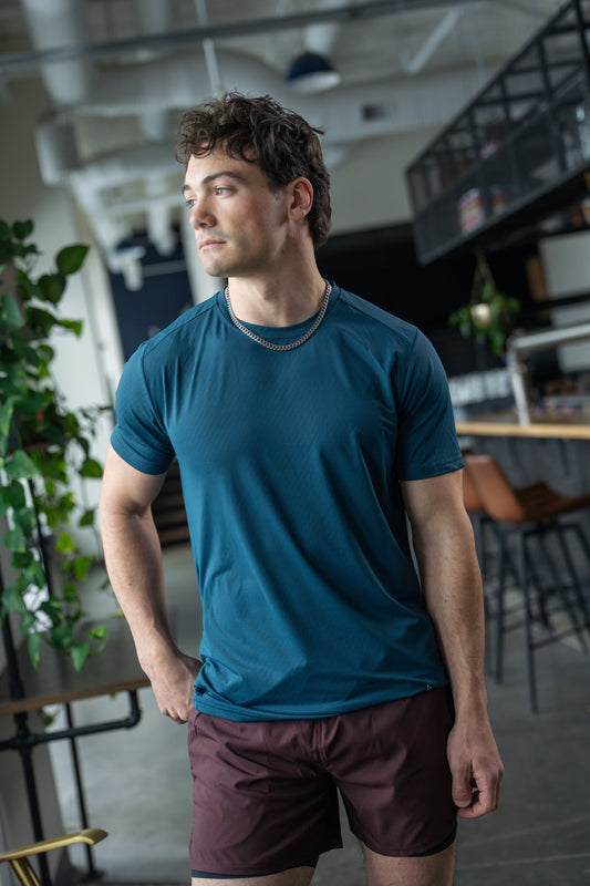 Front view of the blue active tee with short sleeves and round neckline.