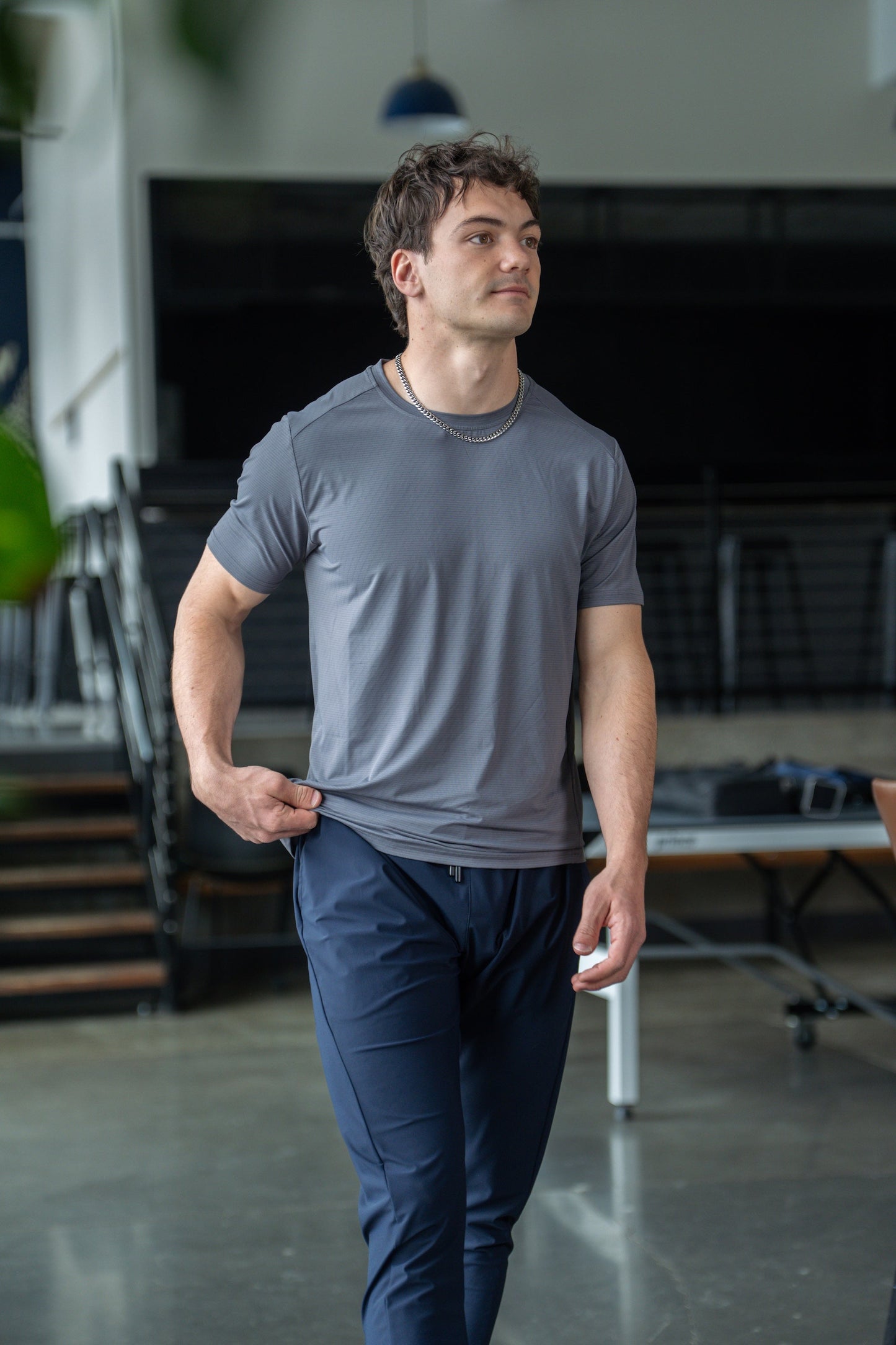 Back view of the green active tee featuring short sleeves and round neckline.