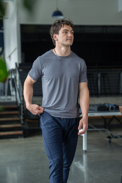 Back view of the green active tee featuring short sleeves and round neckline.