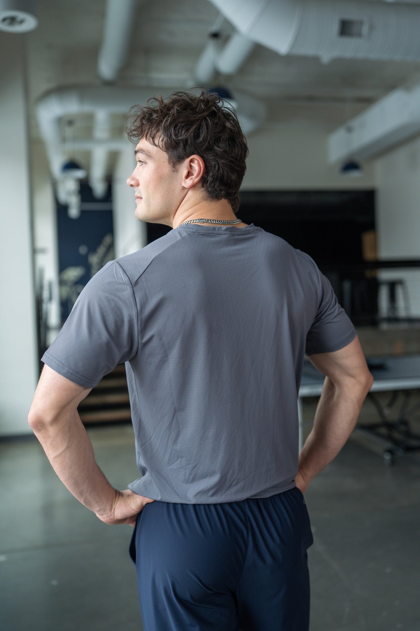 Side view of the green active tee showcasing short sleeves and round neckline.