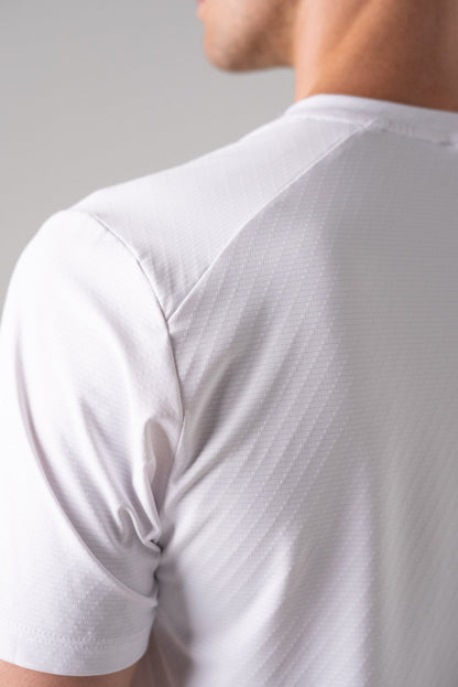 Detail view of the white Alive Strong Tee highlighting the shoulder seam.