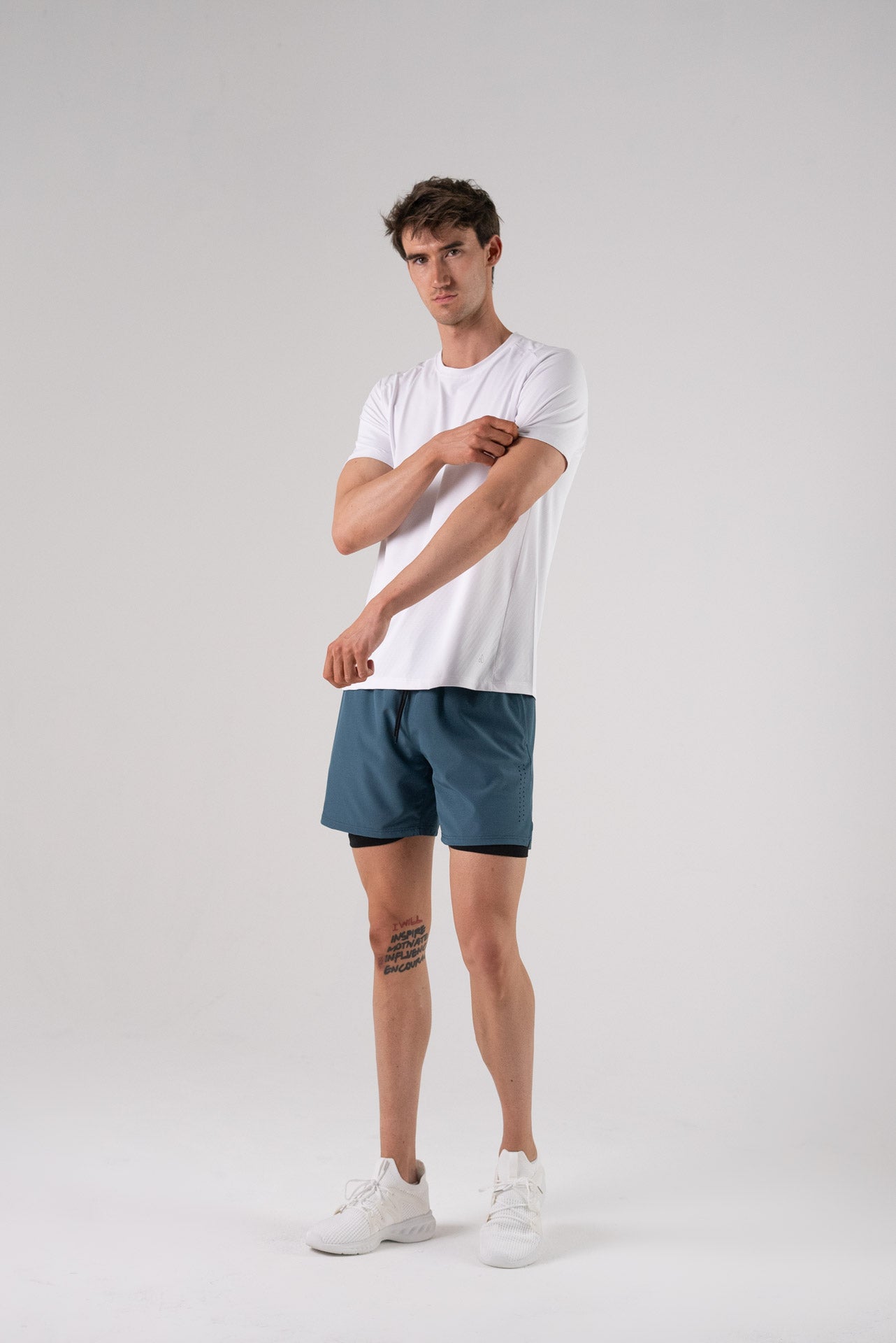 Lifestyle shot of a model wearing the white Alive Strong Tee.