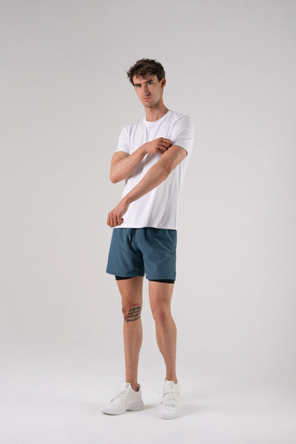 Lifestyle shot of a model wearing the white Alive Strong Tee.