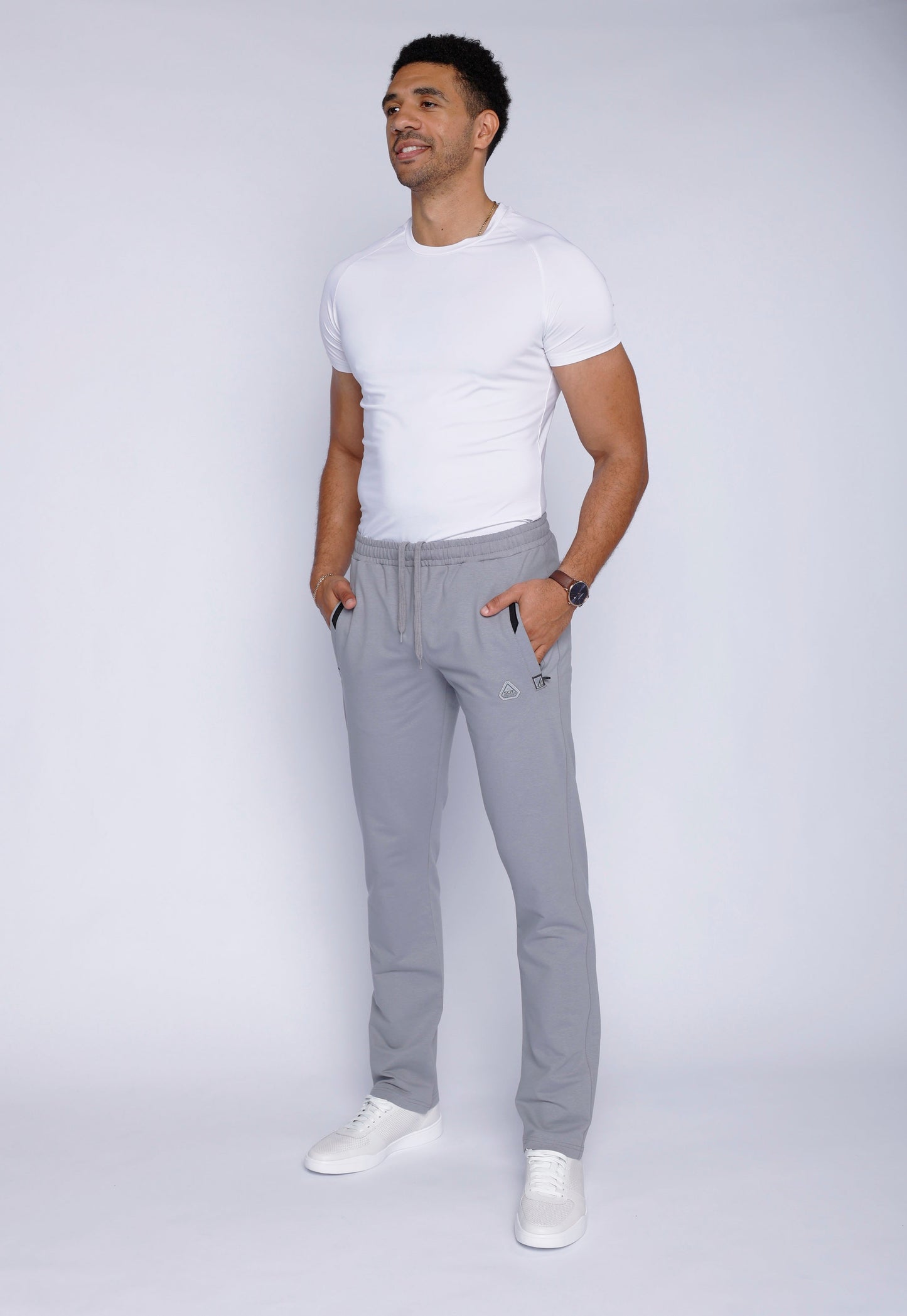 Back view of gray sweatpants featuring a zipper pocket.