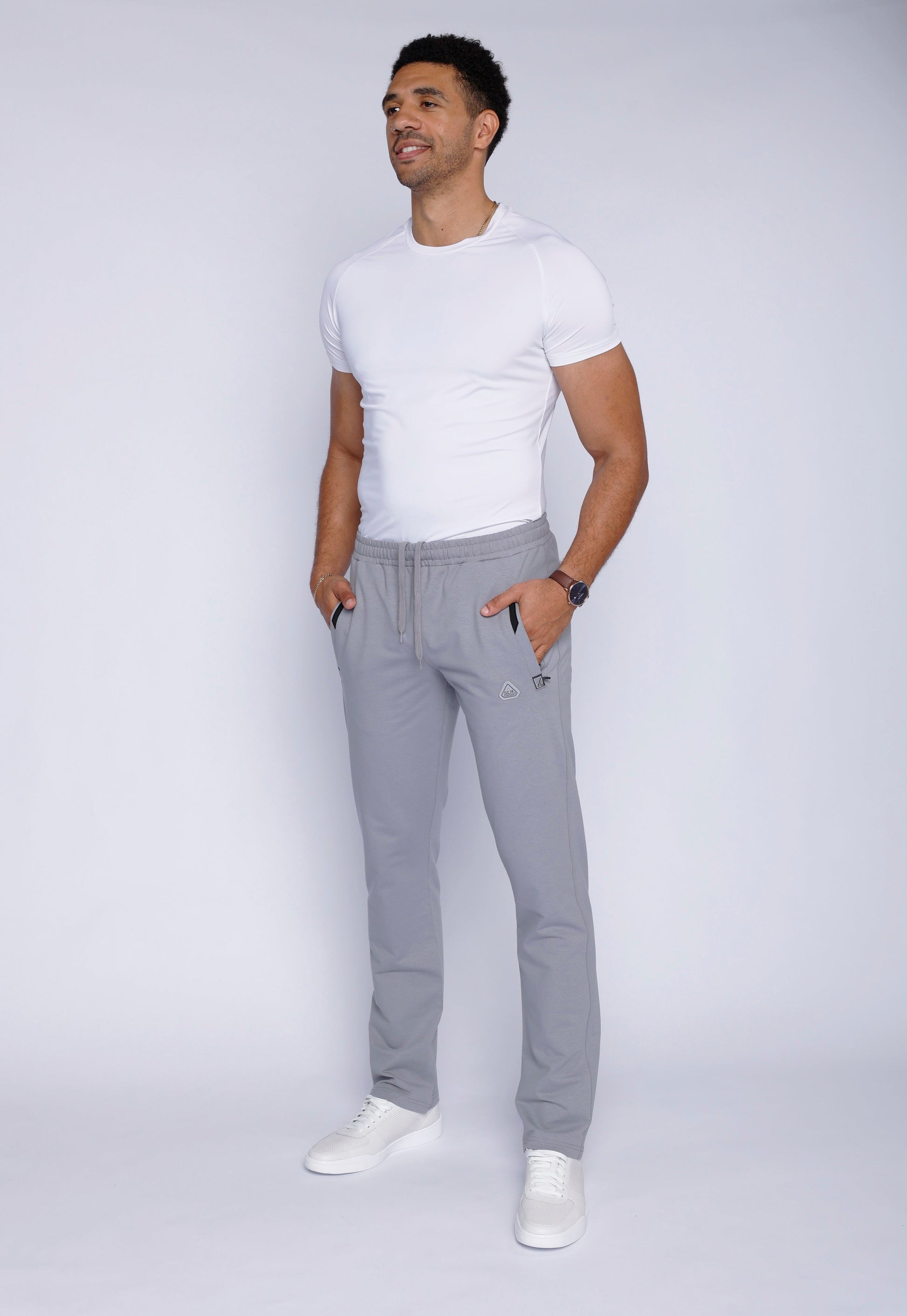 Back view of gray sweatpants featuring a zipper pocket.