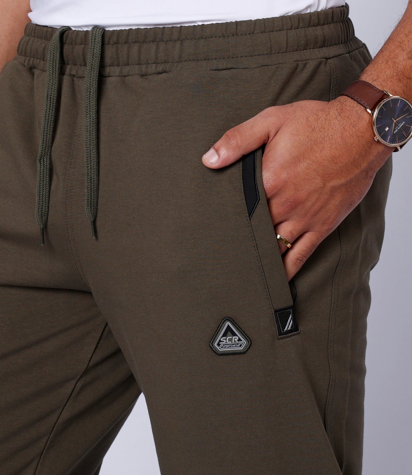 Detail shot of dark khaki stretch lounge pants made from comfortable fabric.