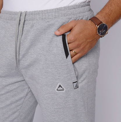 Detail shot of sweatpants with zipper pockets and drawstring.