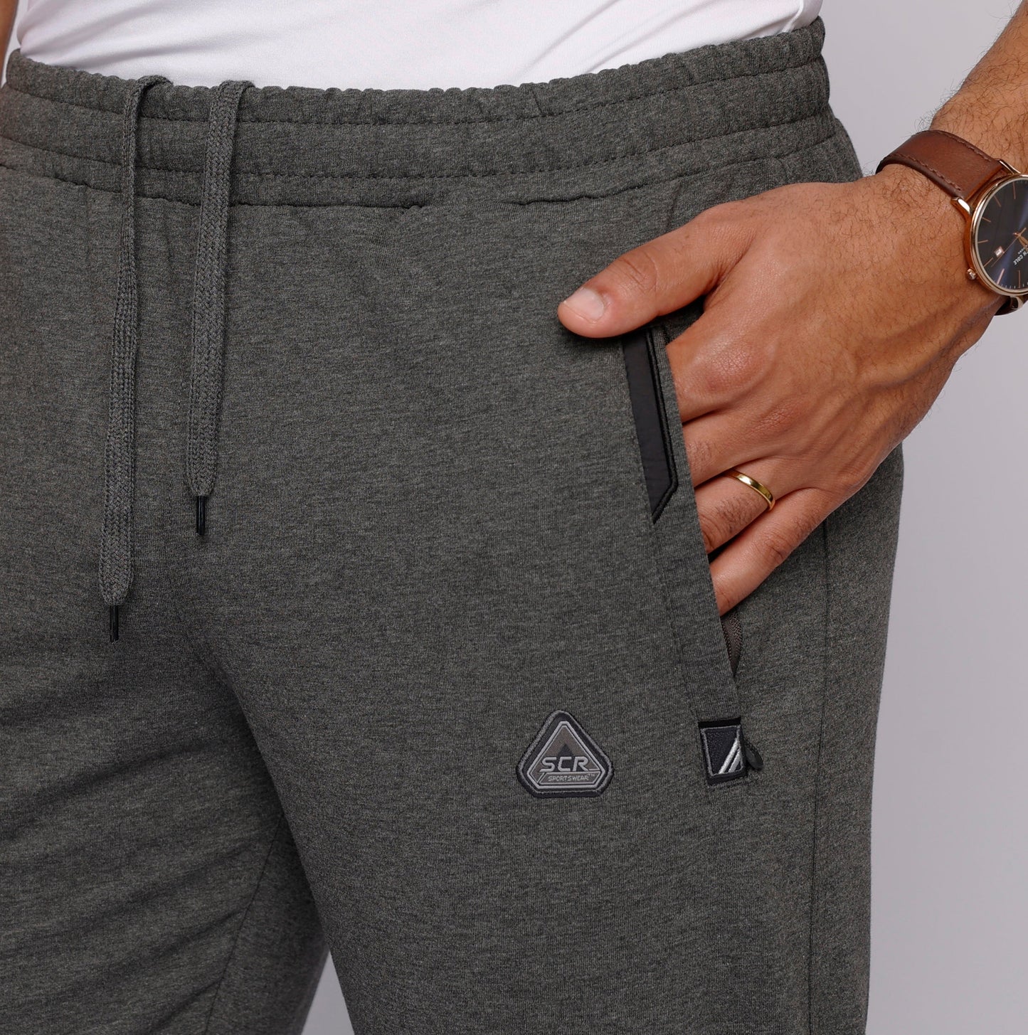 Detail of tall men's sweatpants with zipper pockets in gray.