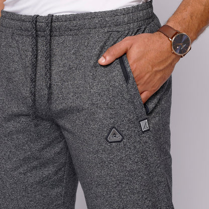 Detail shot of gray sweatpants featuring a pocket and drawstring.