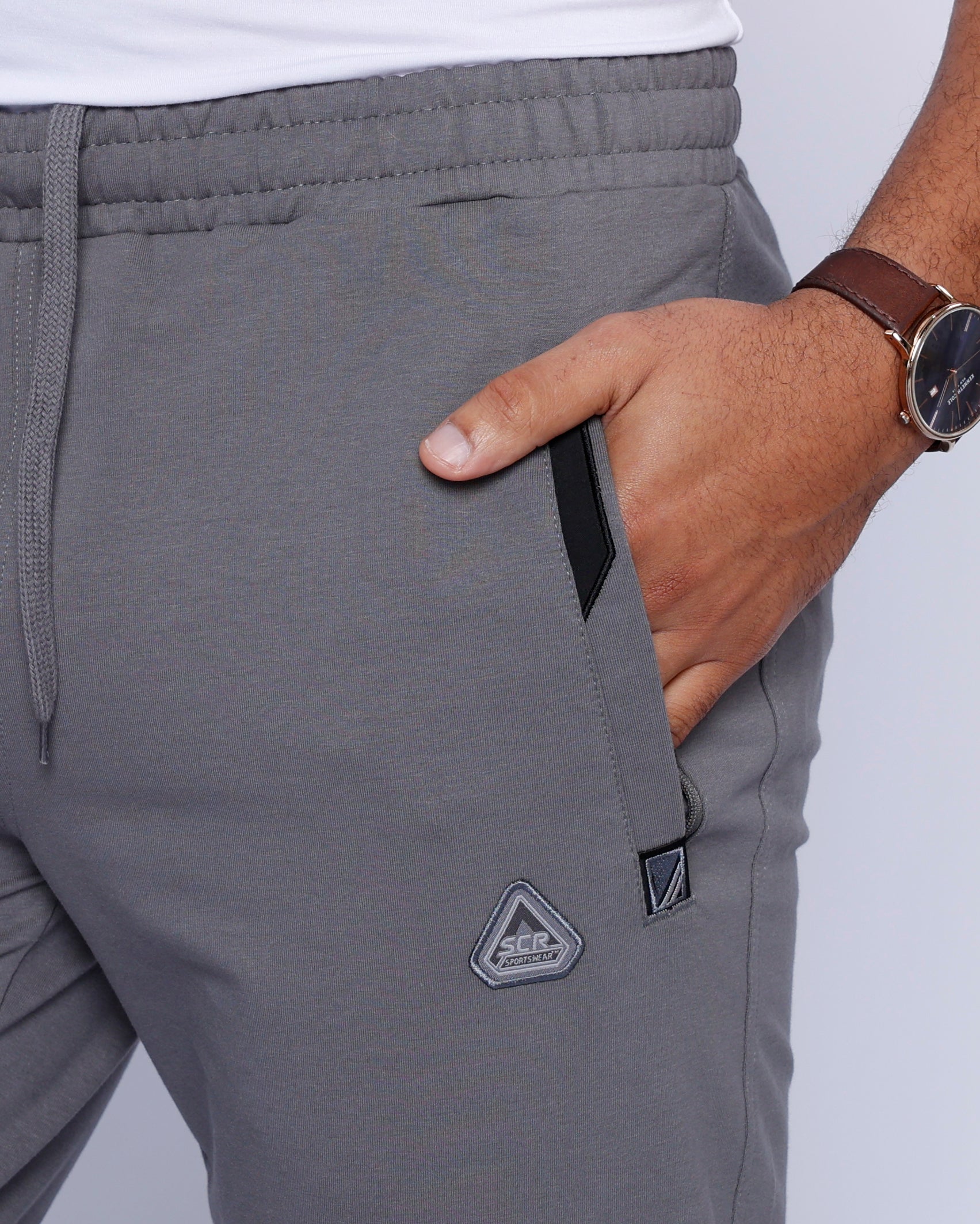 Back view of grey athletic pants featuring pockets and a comfortable fit.