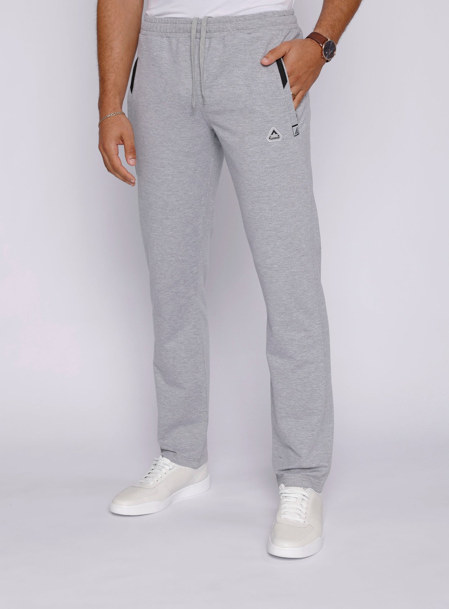 Lifestyle shot of a man in gray sweatpants and casual sneakers.