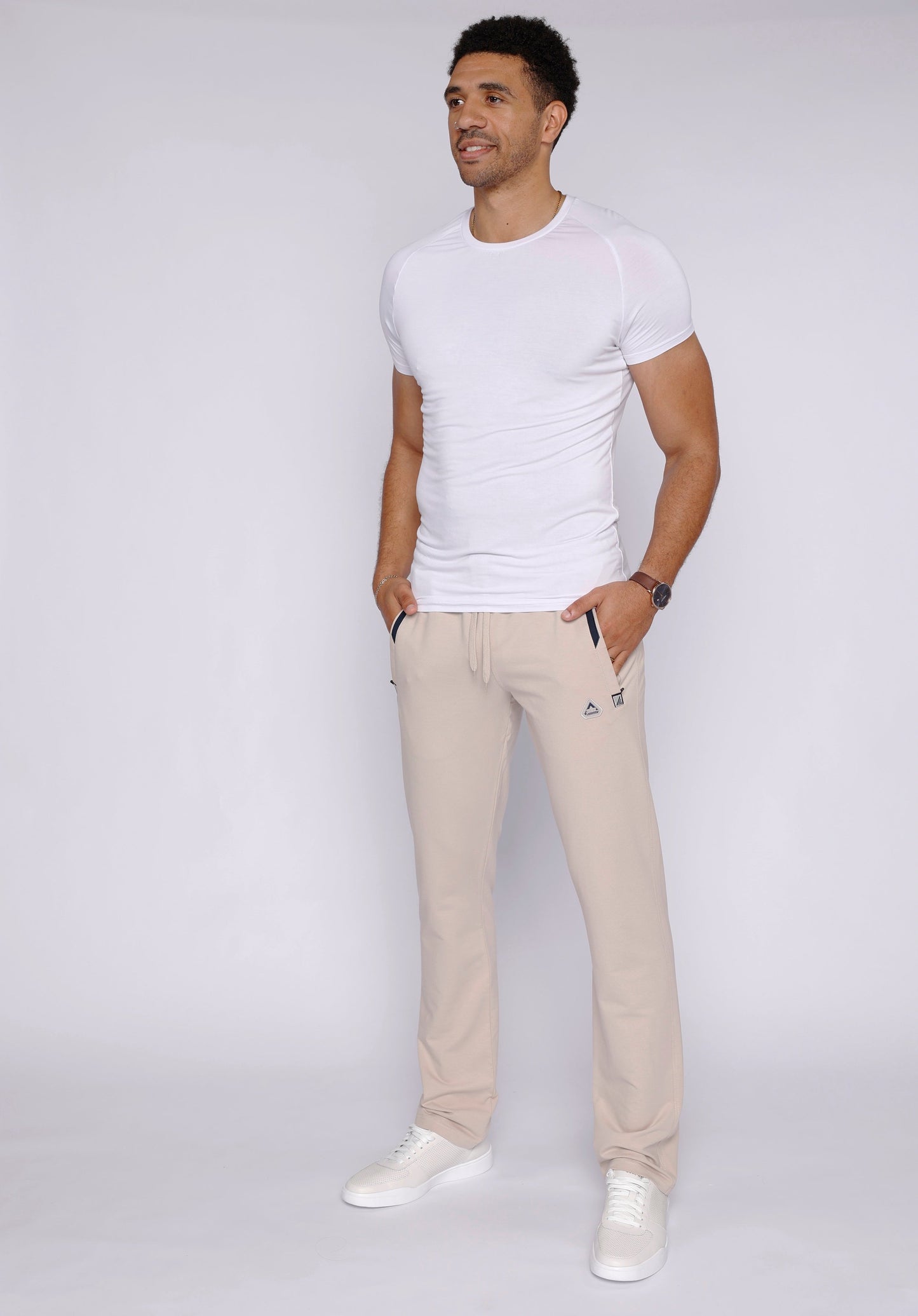 Lifestyle image of a man wearing beige athletic pants.