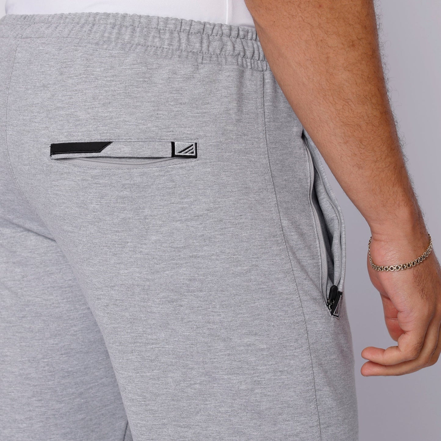 Lifestyle shot of a man wearing grey pants with a t-shirt.