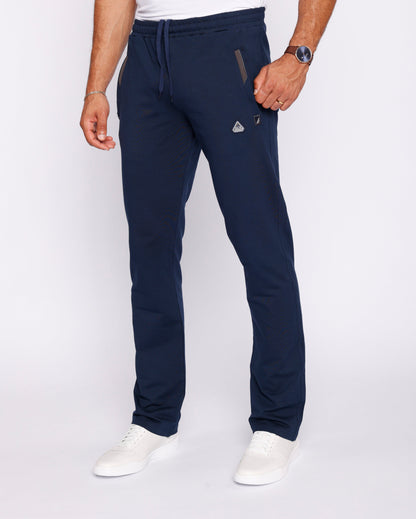 Lifestyle shot of navy blue athletic pants with zipper pockets.