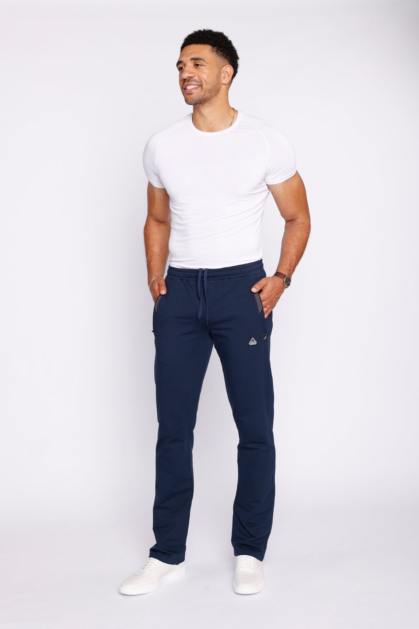 Lifestyle image of men's athletic pants in navy and white.