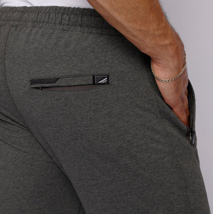 Detail of long inseam sweatpants for men with elastic waistband in gray.