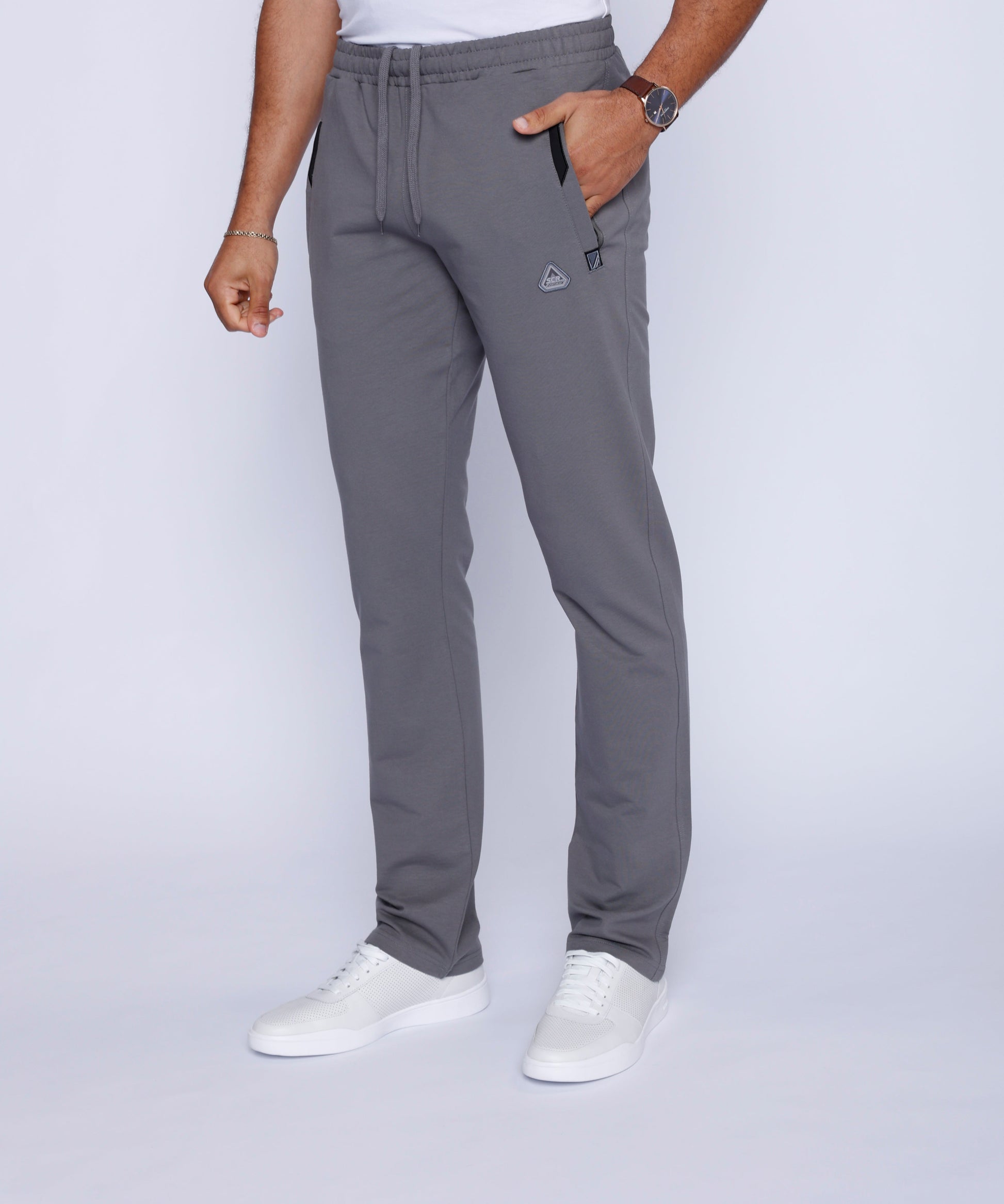 Side view of grey athletic pants showcasing slim fit and pockets.