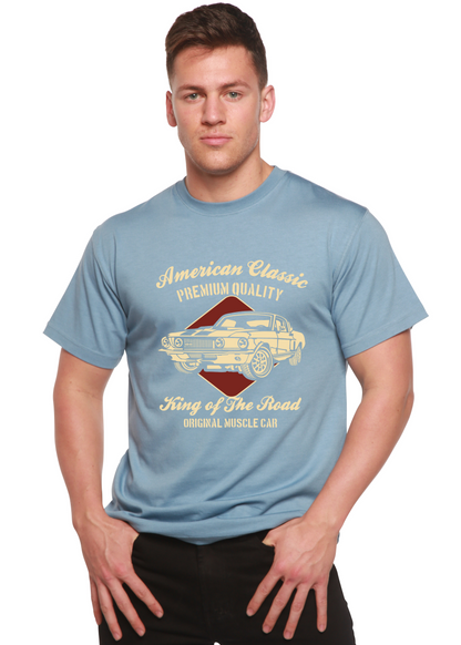Lifestyle shot of the blue graphic t-shirt with gold print.