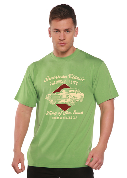 Lifestyle shot of the green graphic t-shirt with gold print.