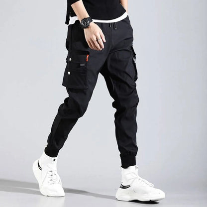 Black Harajuku men's pants side view showcasing pockets and elastic cuffs.