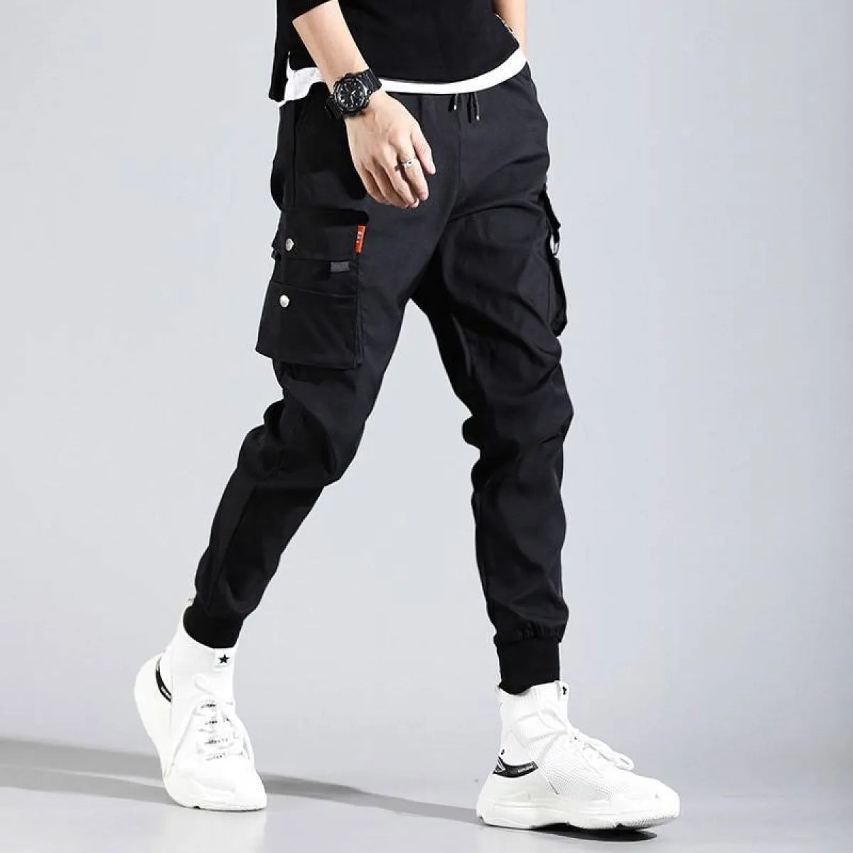 Black Harajuku men's pants side view featuring pockets and elastic cuffs.