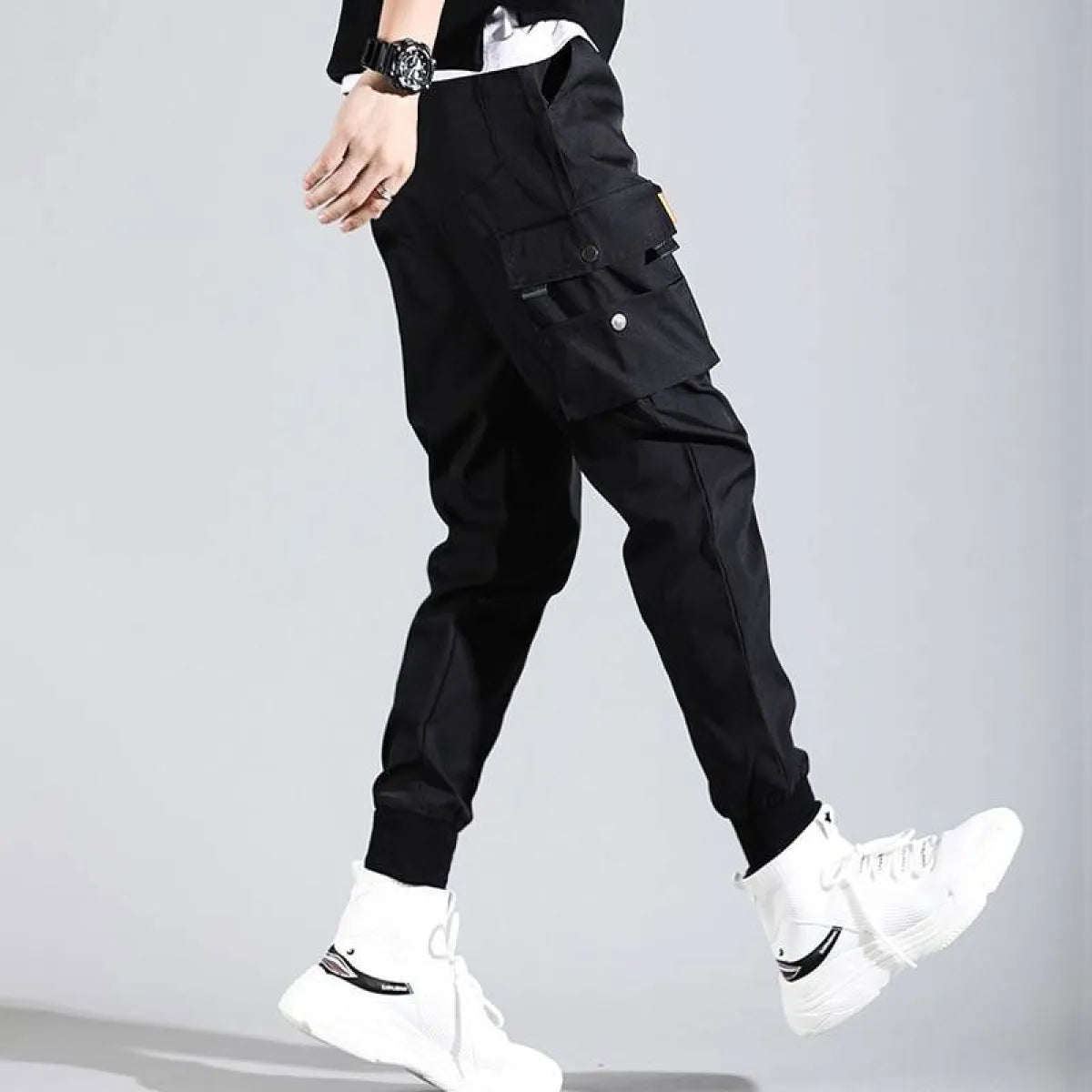 Black Harajuku men's pants side view highlighting pockets and elastic cuffs.