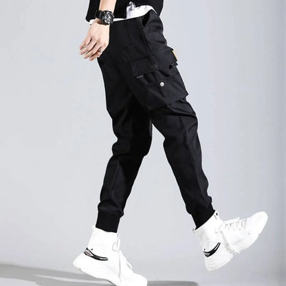 Black Harajuku men's pants side view highlighting pockets and elastic cuffs.