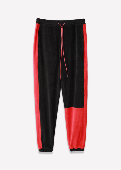 Front view of black joggers with elastic waistband and red side stripes.
