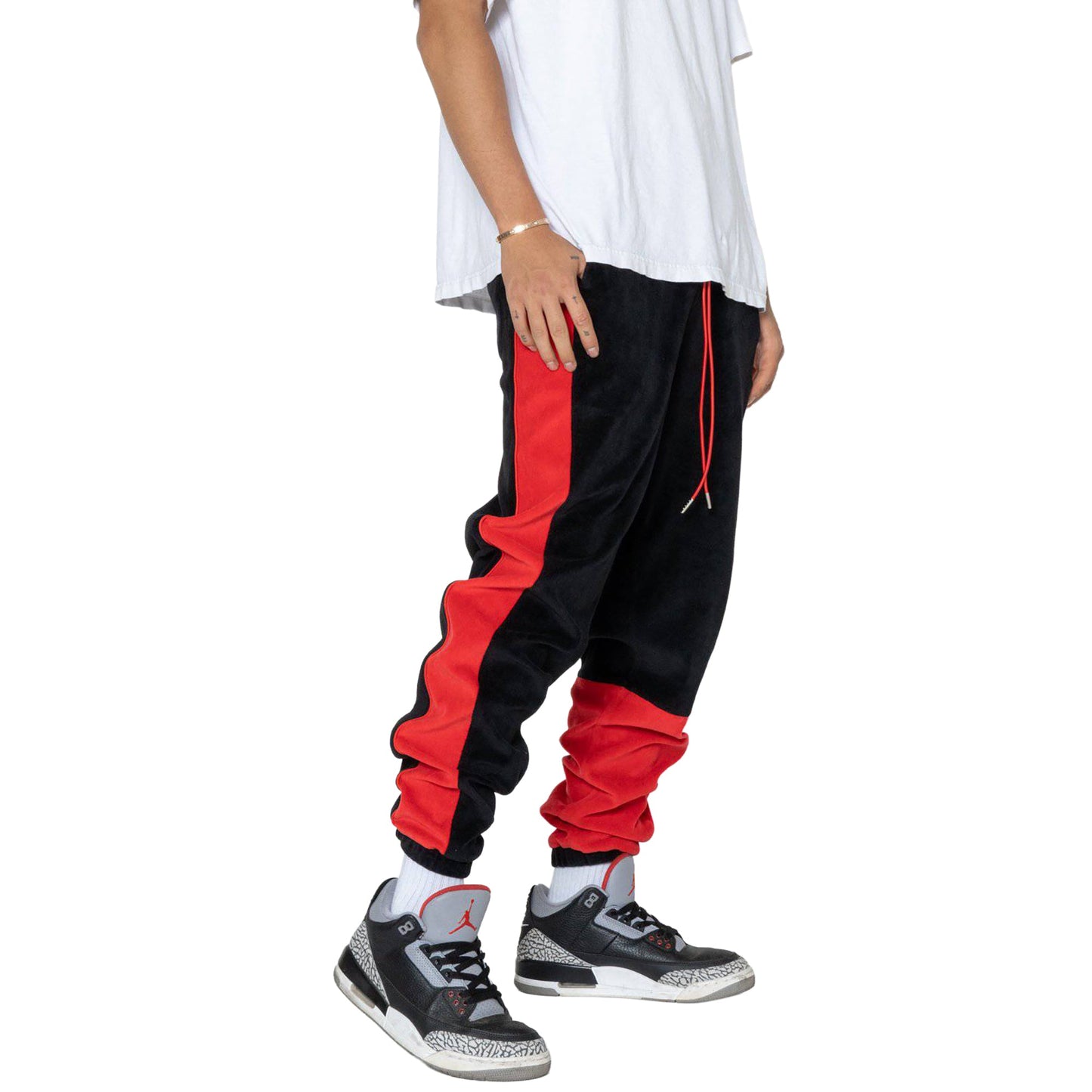 Side view of black joggers featuring elastic waistband and red side stripes.