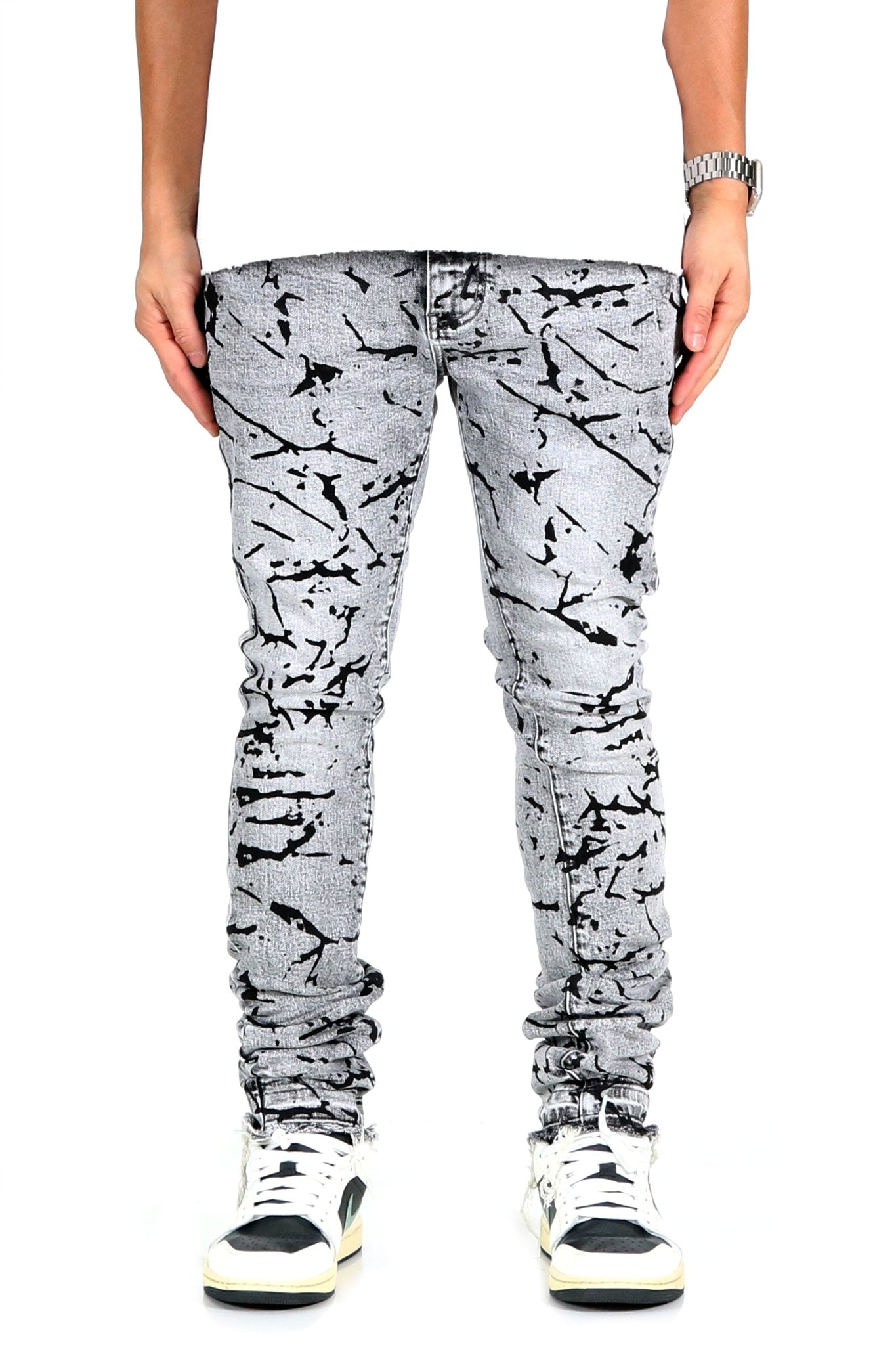 Front view of black and white graphic print skinny denim pants.