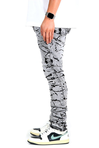 Side view of black and white graphic print skinny denim pants.