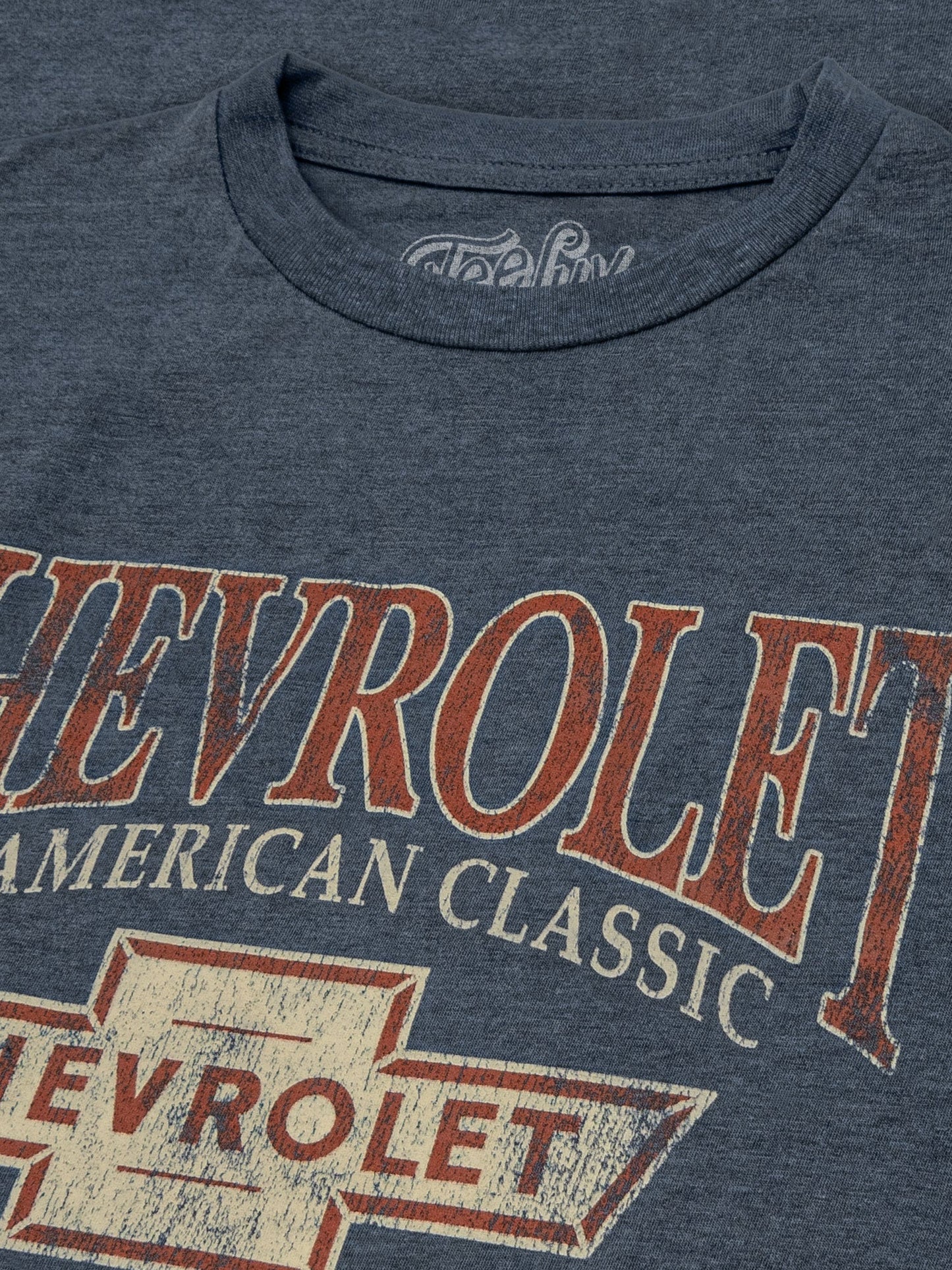 Close-up detail of the round neck collar of the navy t-shirt.