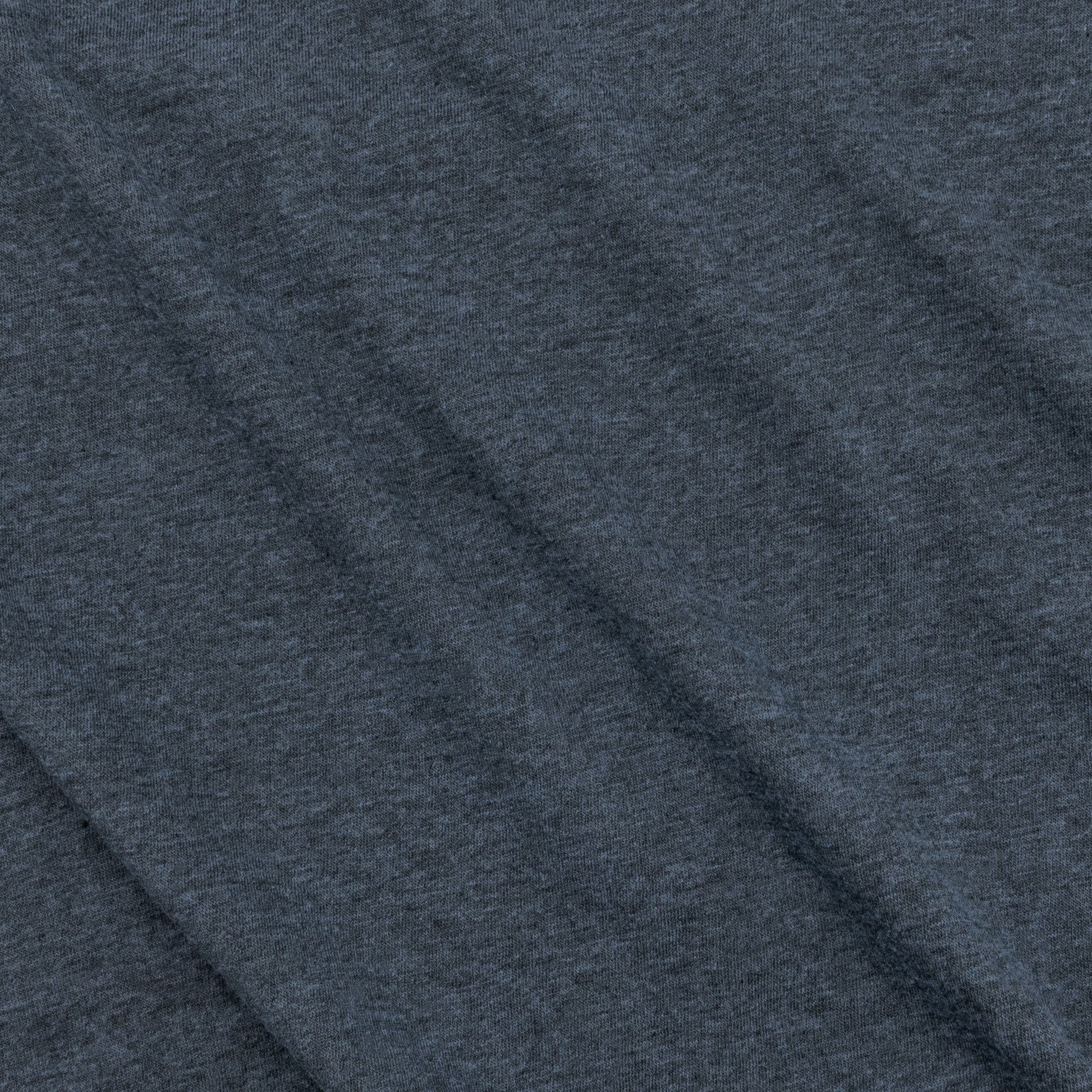 Close-up of the fabric texture showing the soft feel of the navy t-shirt.