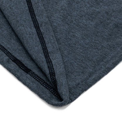 Detail view of the hem of the navy t-shirt featuring a folded hem and clean finish.