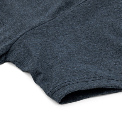 Detail view of the sleeve of the navy t-shirt highlighting soft fabric and seam detail.