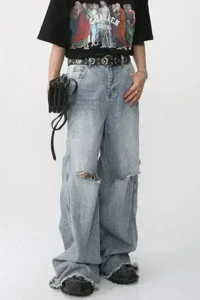 Wide leg light blue distressed jeans in a lifestyle shot.