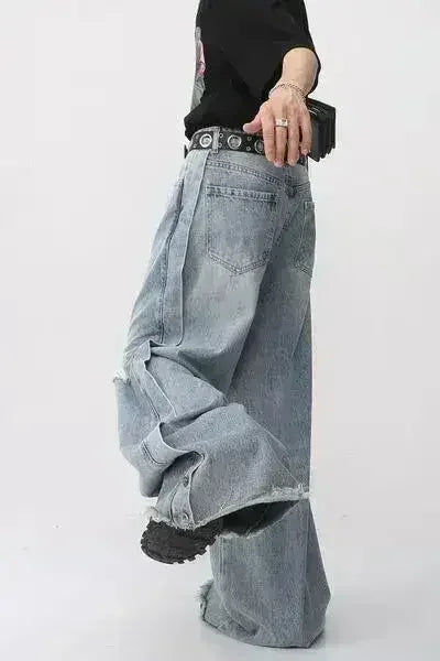 Side view of light blue wide leg distressed jeans.