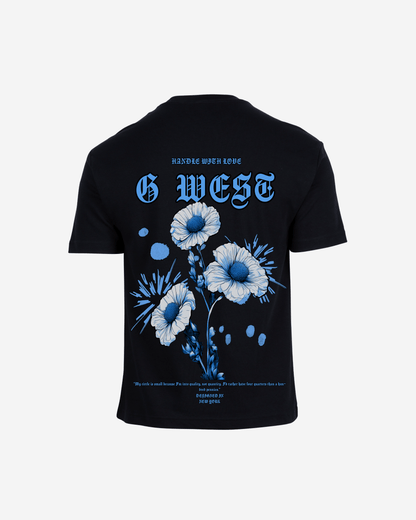 Back view of the black t-shirt featuring a floral graphic print.